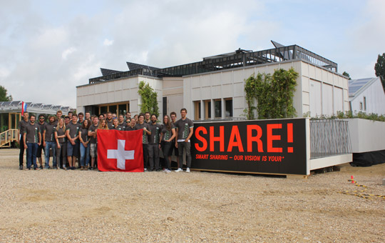 Das Team Lucerne posiert in Versaille vor ihrem Pavillon your+