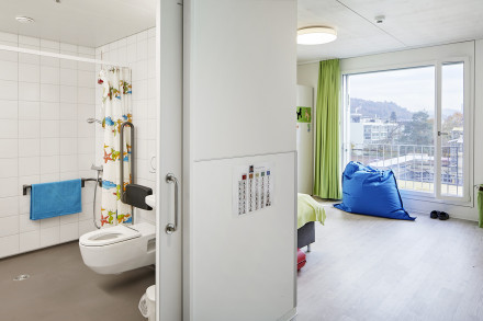 Blick ins Kinderzimmer und hindernisfreiem Badezimmer mit Dusche und Toilette