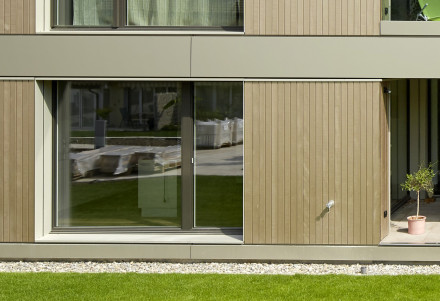 Immeuble d’habitation à Rheinfelden avec une couverture en tôle d’Alucobond destinée à protéger le façade en bois des éclaboussures.