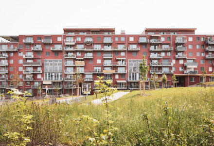 Vue frontale de la façade longitudinale du bâtiment rouge.