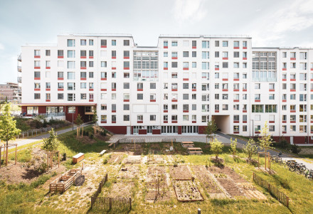 Vue frontale de la façade longitudinale du bâtiment blanc