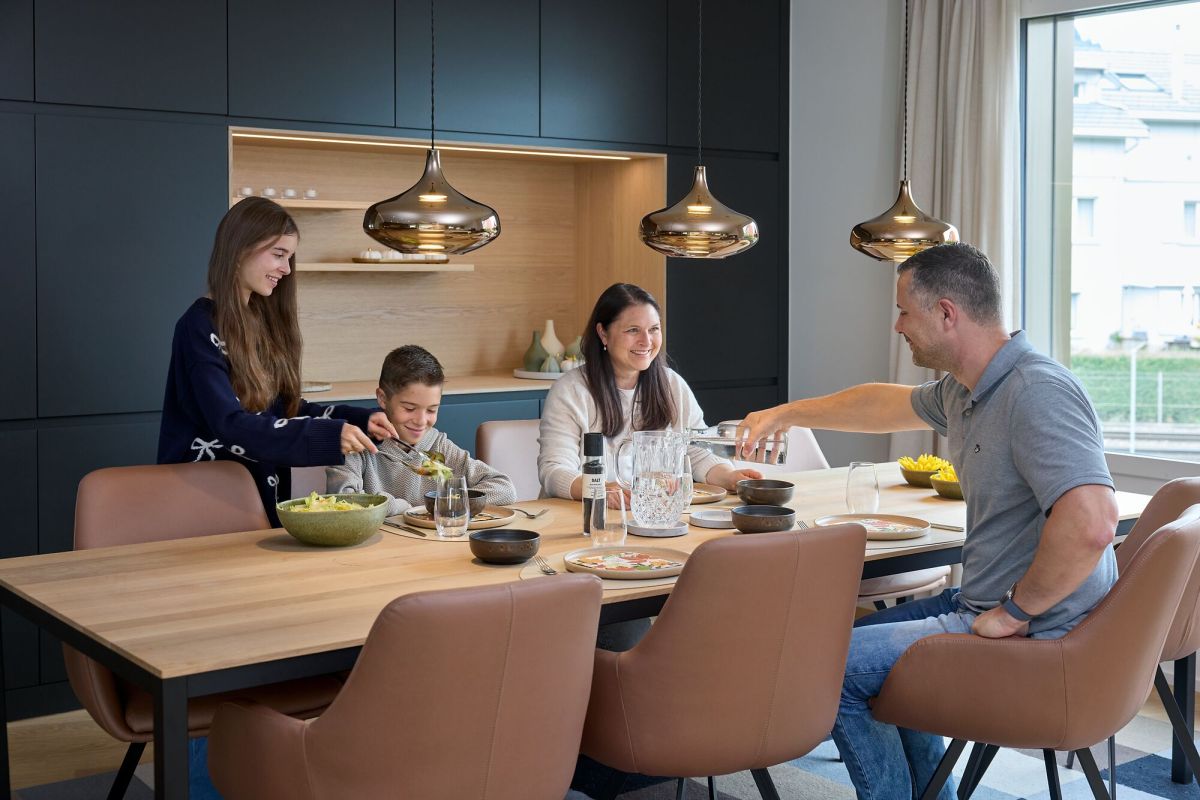 Une famille est assise à table en train de manger